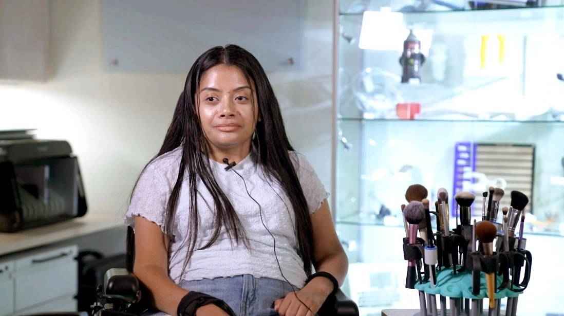 Brenda Guevara sitting next to a makeup brush holder