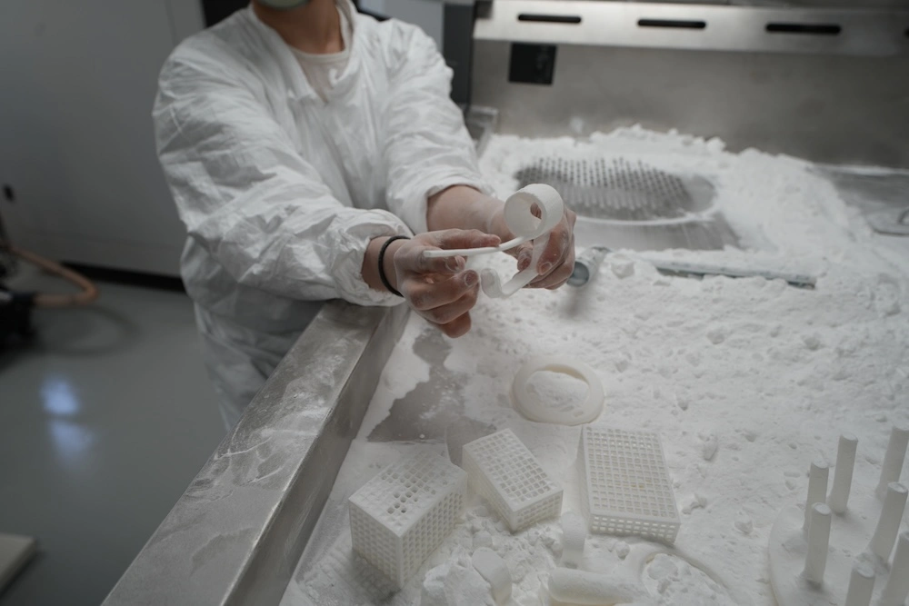 Person holding 3d printed pieces for the makeup brush holder