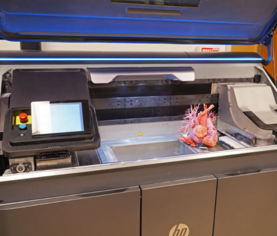 A large 3d printer in use. Creating a model of the human heart.